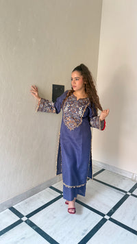 Thread embroidery work with coin tassels
