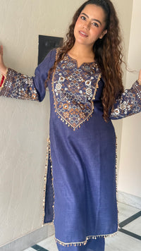 Thread embroidery work with coin tassels