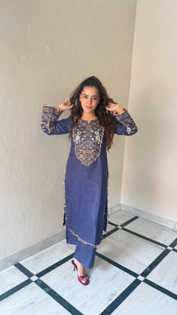 Thread embroidery work with coin tassels