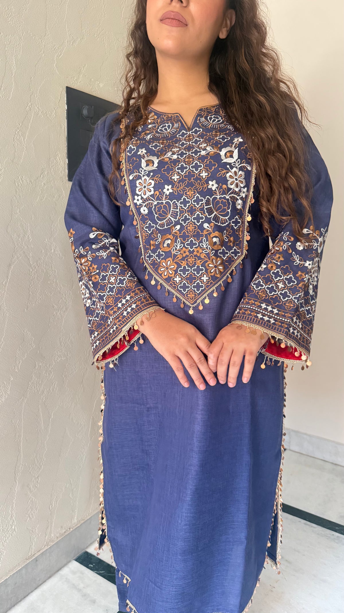 Thread embroidery work with coin tassels